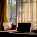 Focused workspace with laptop and notebook representing a consistent daily affiliate marketing routine