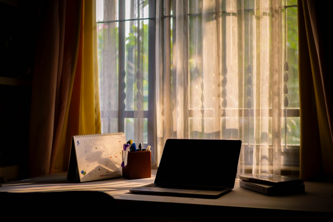 Focused workspace with laptop and notebook representing a consistent daily affiliate marketing routine