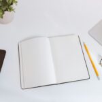 Minimal workspace with laptop and planning notes representing focused affiliate marketing execution